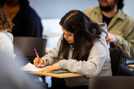Student taking notes
