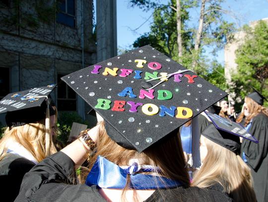 Grad cap reading "To infinity and beyond"