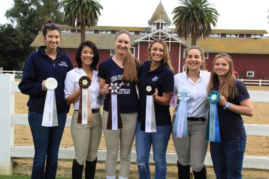 Equestrian team members proudly display their awards. 