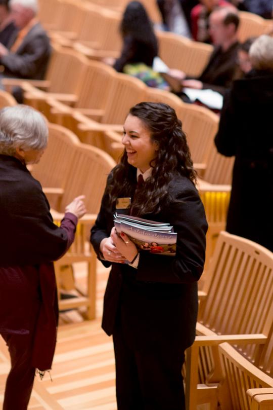 green music center worker talking to a community member 