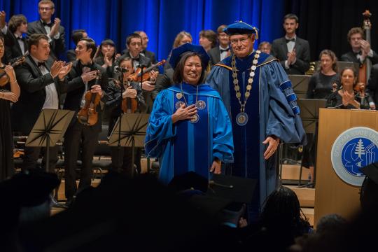 judy sakaki in ceremony with chancellor timothy white