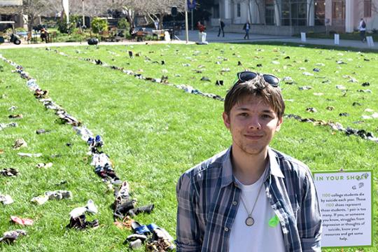 Ben Teurlay next to his art piece 