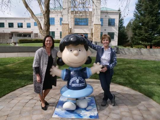 President Judy K. Sakaki and Jeanie Schulz with SSU's new Lucy statue