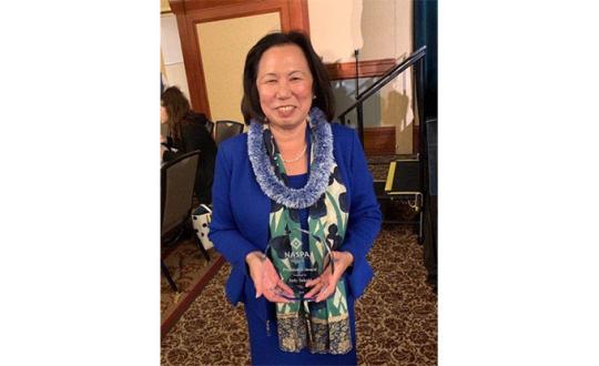President Judy Sakaki holding her NASPA award