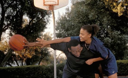Still from Gina Prince-Bythewood's film "Love & Basketball" (2000). a couple playing basketball.