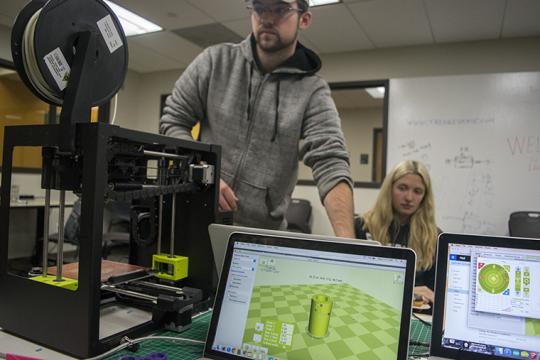 Students using 3D printer in Makerspace