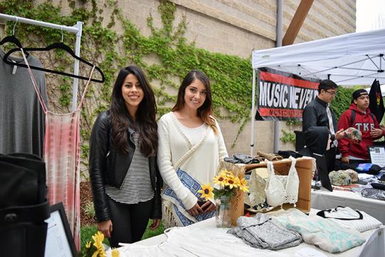 two women selling clothes at booth