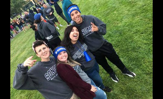 Carly Solberg poses with students for slefie