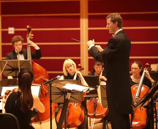 conductor leading orchestra