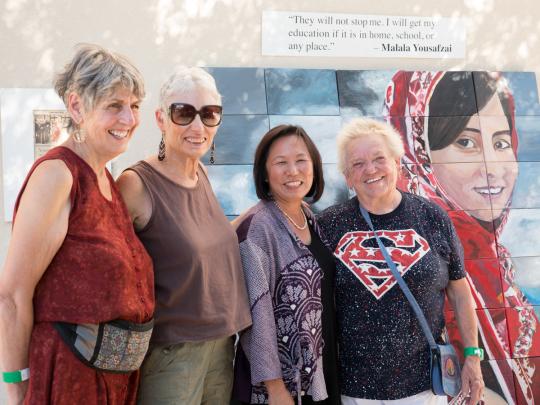 President Sakaki with guests and a painting of Malala