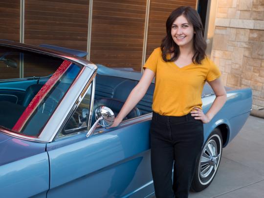 woman with classic Mustang