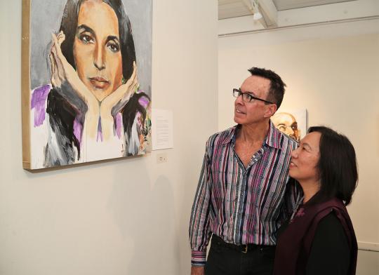 SSU President Judy Sakaki and FIGR Tribal Chairman Greg Sarris admire a self-portrait by Joan Baez