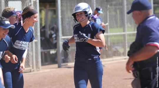 softball players celebrating home run