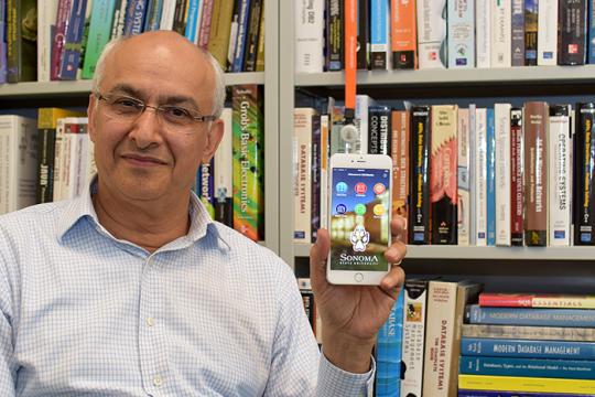 SSU computer science professor Ali Kooshesh holds up an iPhone showing SSU's redesigned mobile app.