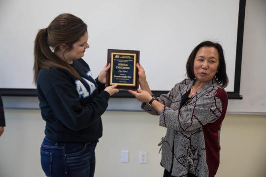 President Sakaki presenting the award to Shannon Brown, the editor-in-chief of the STAR // Photo by Alyssa Archerda 