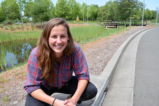  Kara Kelly crouches atop a drain that leads to a manmade wetland at the Green Music Center at Sonoma State. 