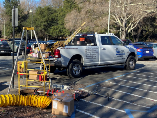 A Pacific Industry Electrical Construction vehicle on a campus work site
