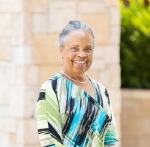 Portrait of Anita Christmas smiling in an outdoor setting