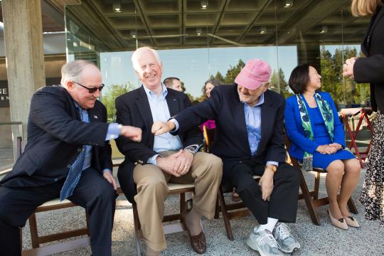 Gary Heck, president and owner of Korbel Champagne Cellars, and Wine Spectator editor and publisher Marvin R. Shanken, give each other a fist bump as Rep. Mike Thompson, D-St. Helena, looks on.